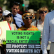Voting Rights Act supporters listen to the Supreme Court's ruling on Tuesday. (Win McNamee/Getty Images)